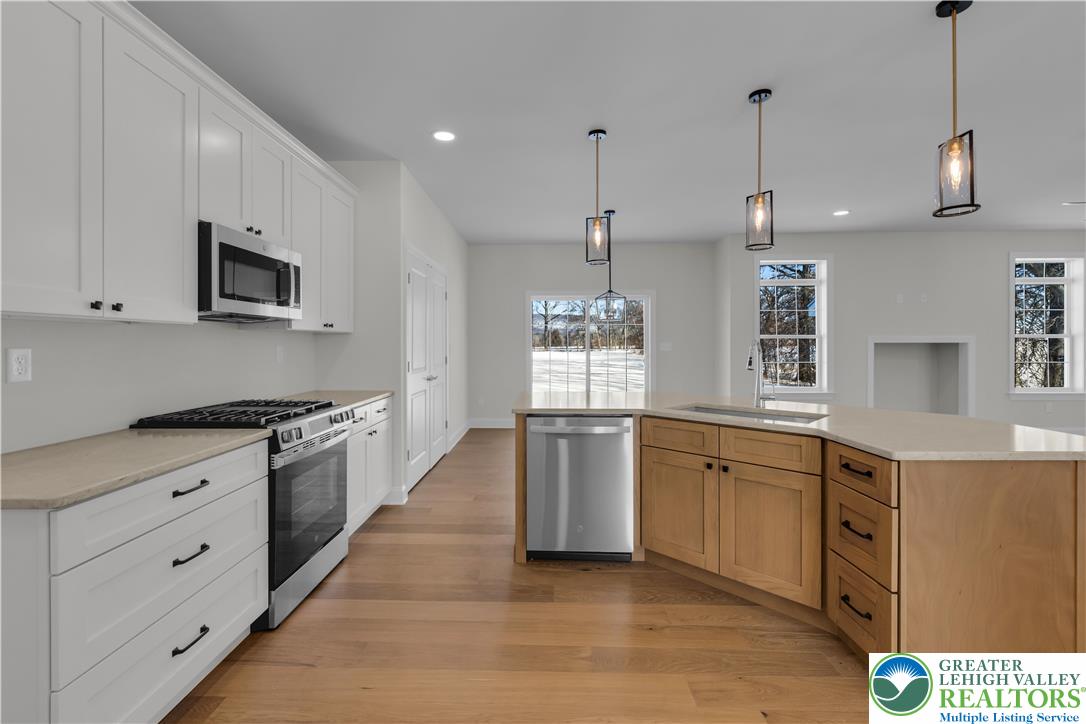 1480 Bushkill Center Road Nazareth, PA 18064 - Photo 17 of 55 a kitchen with stainless steel appliances granite countertop a stove a sink and a refrigerator