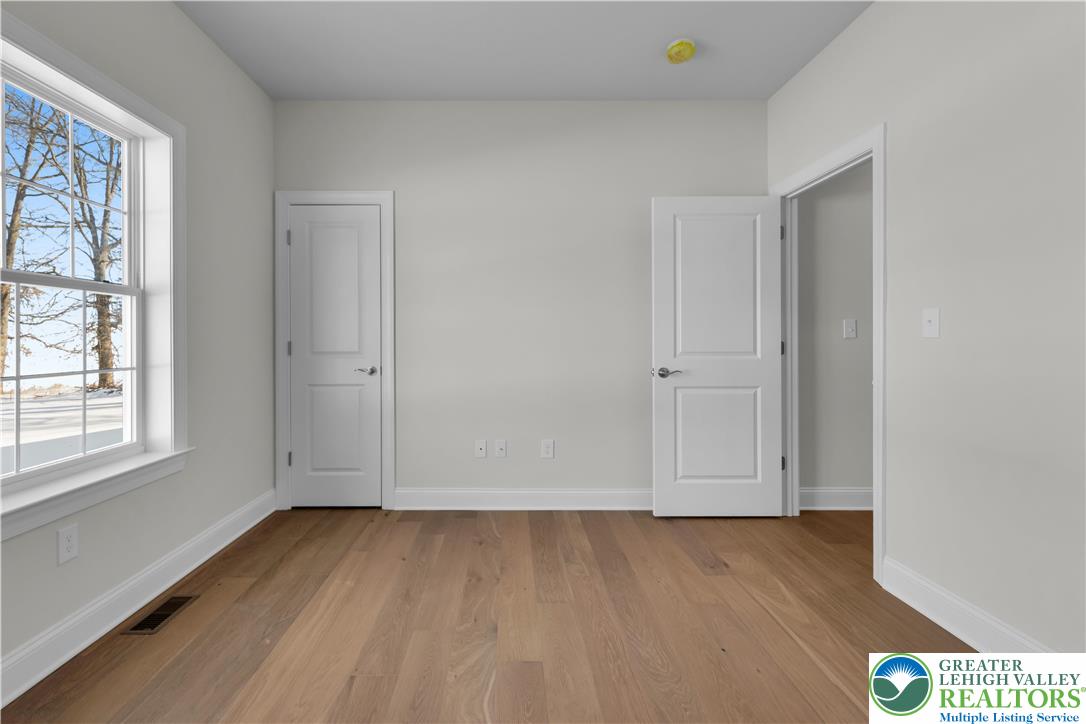 1480 Bushkill Center Road Nazareth, PA 18064 - Photo 23 of 55 an empty room with wooden floor and windows