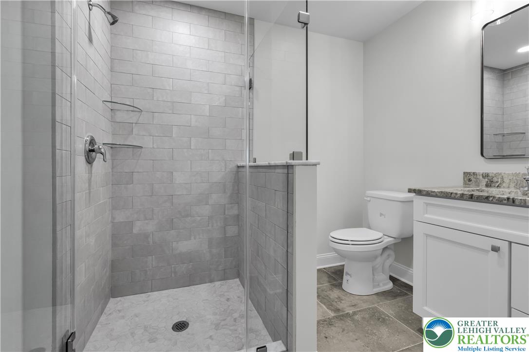 1480 Bushkill Center Road Nazareth, PA 18064 - Photo 35 of 55 a bathroom with a toilet sink vanity and shower