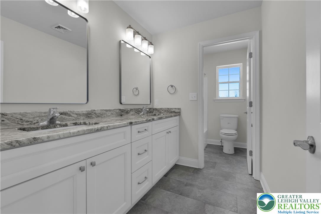 1480 Bushkill Center Road Nazareth, PA 18064 - Photo 41 of 55 a bathroom with a granite countertop sink and a mirror
