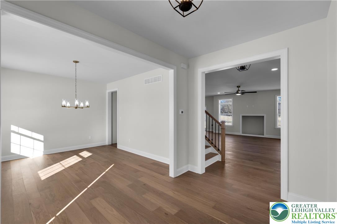 1480 Bushkill Center Road Nazareth, PA 18064 - Photo 10 of 55 a view of a livingroom with wooden floor and a ceiling fan