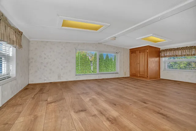 wooden floor in an empty room with a window