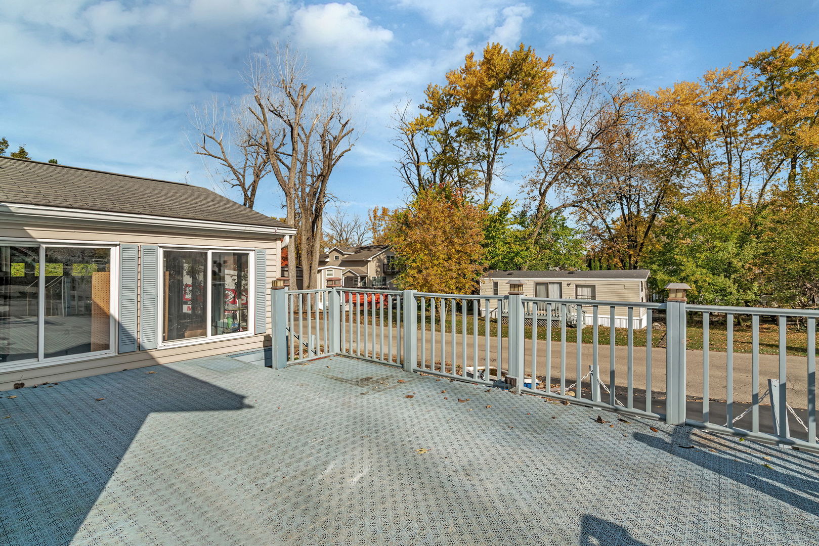 64 Fossil Ridge Road Wilmington, IL 60481 - Photo 5 of 40 a view of a house with a wooden deck and a large window