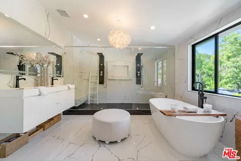a spacious bathroom with a large tub sink and toilet