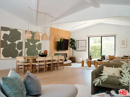 a living room with furniture large window and flat screen tv