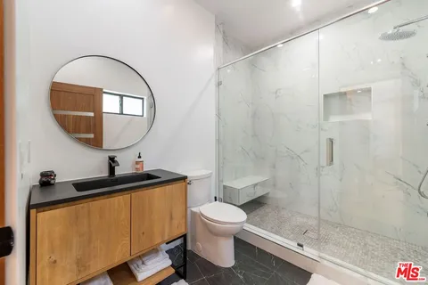 a bathroom with a sink toilet and shower