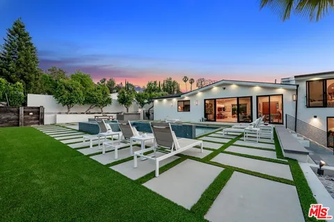 a view of a house with backyard porch and sitting area