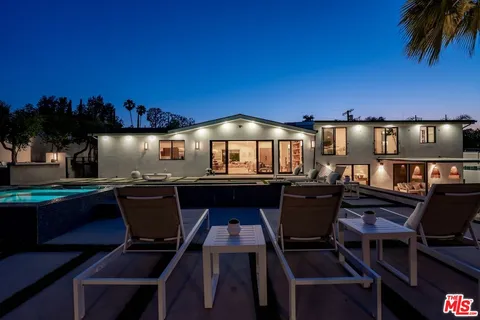 a kitchen with a table and chairs