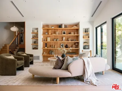 a living room with furniture and a floor to ceiling window