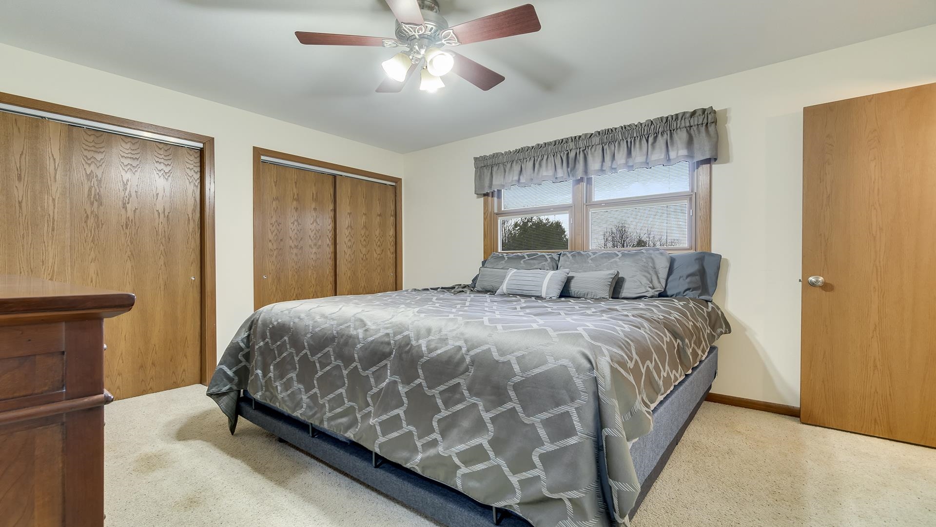 11764 North Tower Road Byron, IL 61010 - Photo 13 of 38 a bedroom with a bed and a chandelier