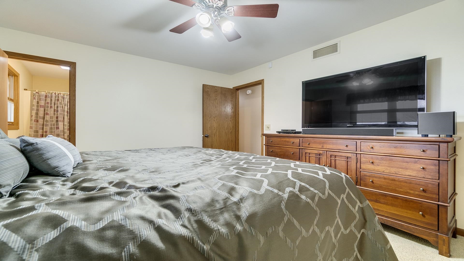 11764 North Tower Road Byron, IL 61010 - Photo 14 of 38 a bedroom with a bed and flat screen tv