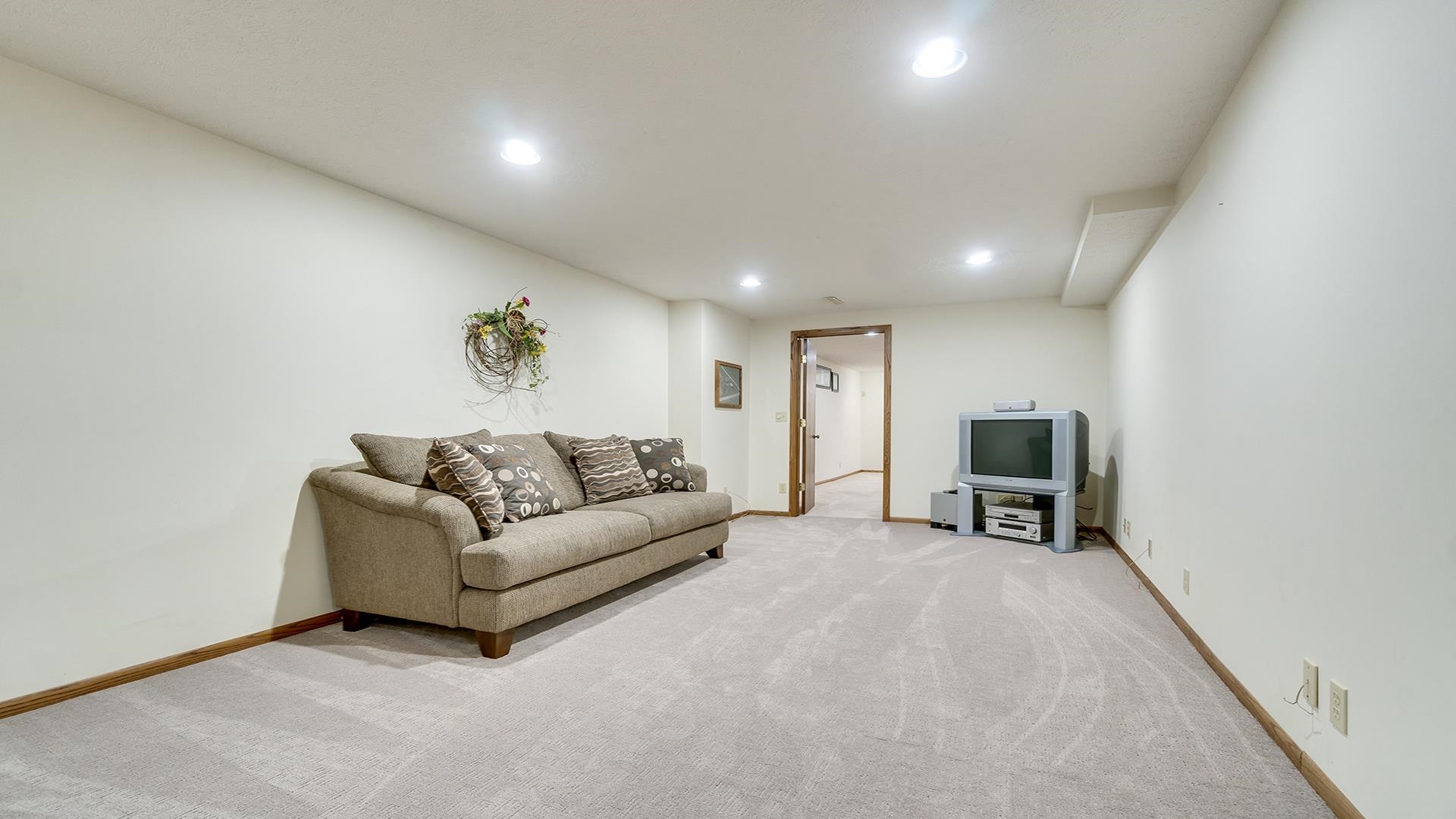11764 North Tower Road Byron, IL 61010 - Photo 20 of 38 a living room with furniture a fireplace and a flat screen tv