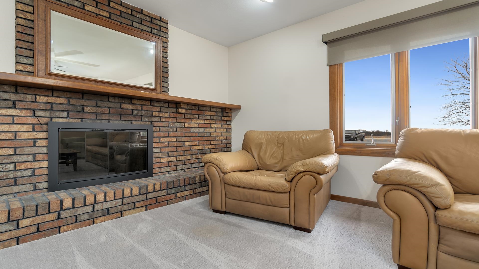 11764 North Tower Road Byron, IL 61010 - Photo 6 of 38 a living room with furniture a flat screen tv a rug and a fireplace
