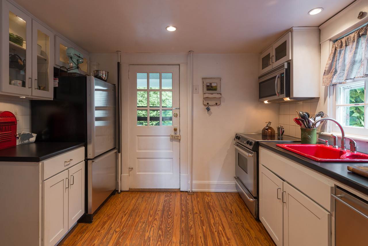 525 Valley Road Charlottesville, VA 22903 - Photo 5 of 14 a kitchen with granite countertop stainless steel appliances a sink cabinets and a counter space