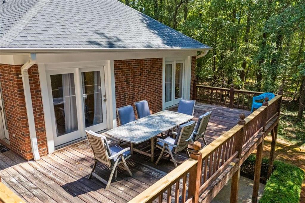 750 Staghorn Trail Nicholson, GA 30565 - Photo 37 of 55 a view of a patio with table and chairs with wooden floor and fence