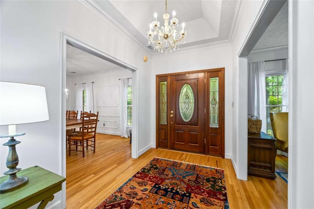 750 Staghorn Trail Nicholson, GA 30565 - Photo 5 of 55 a view of a hallway to a livingroom with furniture wooden floor cabinet and front door