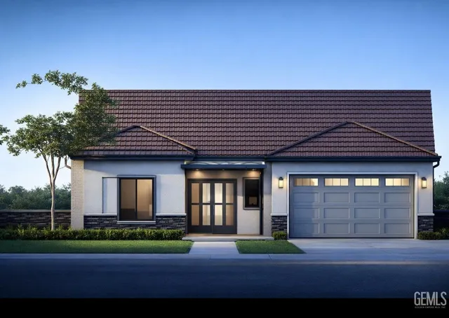 a front view of a house with a garden and yard