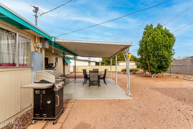 a view of a patio with table and chairs and potted plants