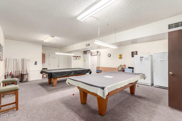 a room with pool table and windows