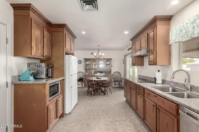 a kitchen with cabinets a sink and appliances