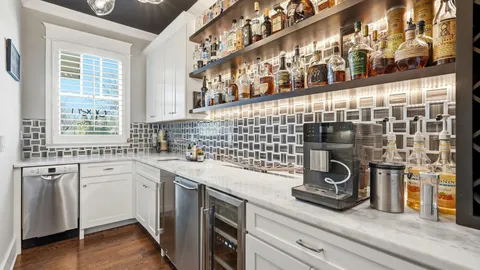 a view of a dining room with furniture large windows and wooden floor