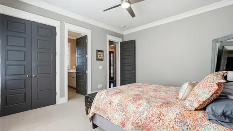 a en suite bathroom with a granite countertop sink and a large mirror