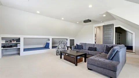 a living room with furniture a clock and a large window