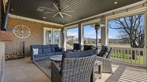 a view of swimming pool with outdoor seating and yard in the back