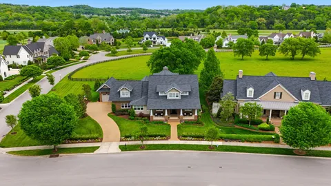 a kitchen with stainless steel appliances granite countertop a stove a sink dishwasher and a refrigerator with wooden floor