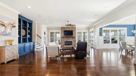 a living room with fireplace furniture and a wooden floor