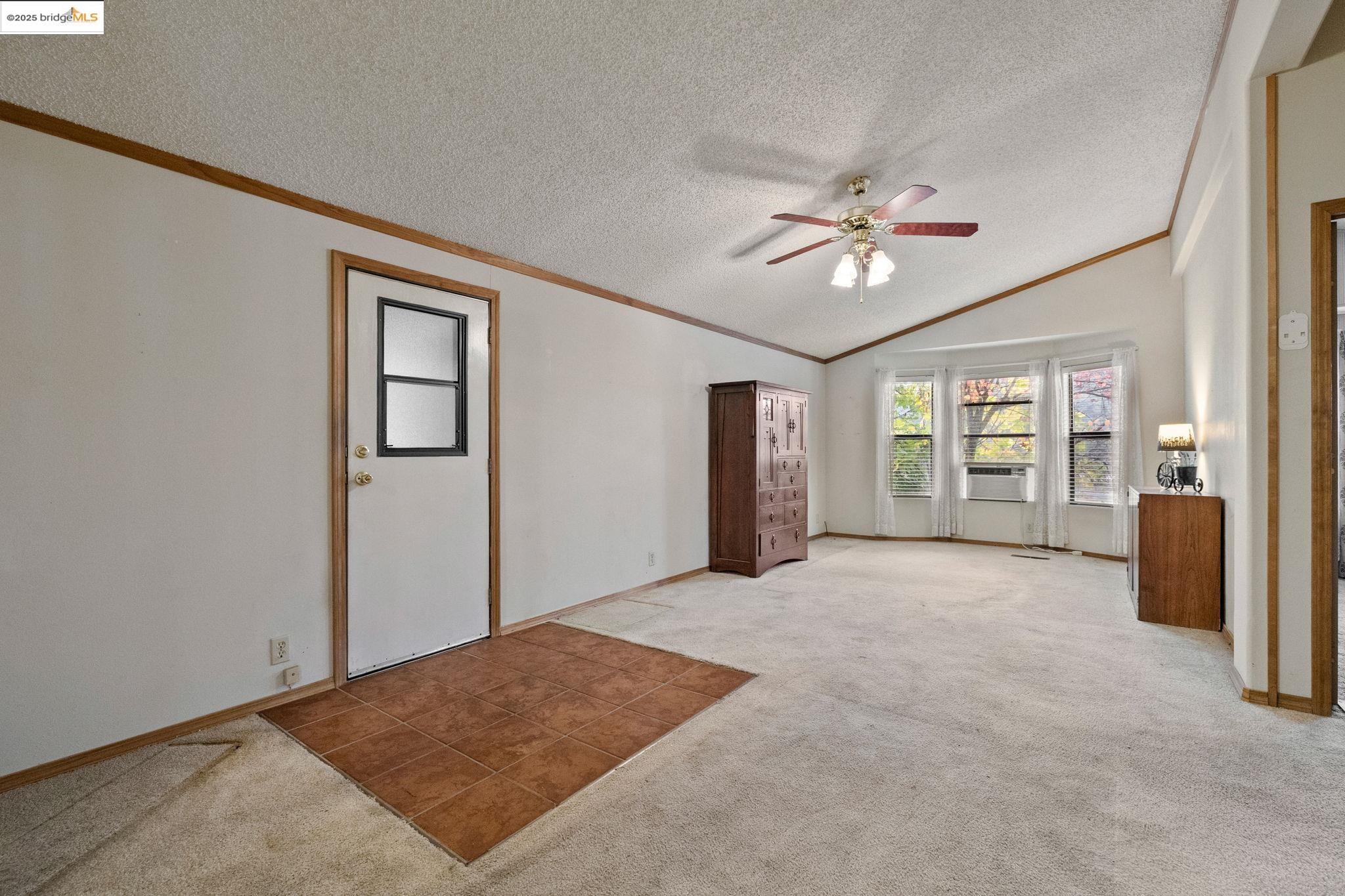 18717 Mill Villa Road, Unit 340 Jamestown, CA 95327 - Photo 11 of 21 a view of a big room with windows and chandelier fan