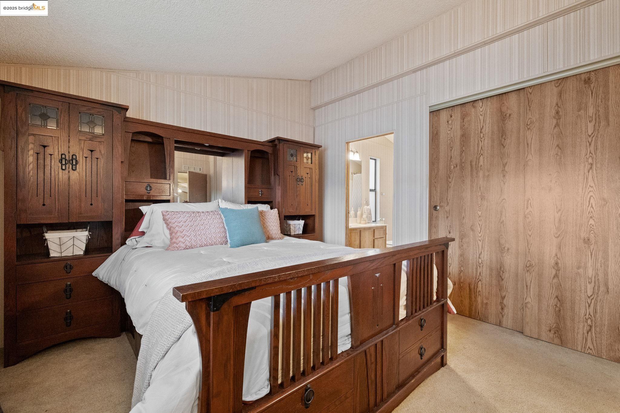 18717 Mill Villa Road, Unit 340 Jamestown, CA 95327 - Photo 14 of 21 a bedroom with a bed and wooden floor