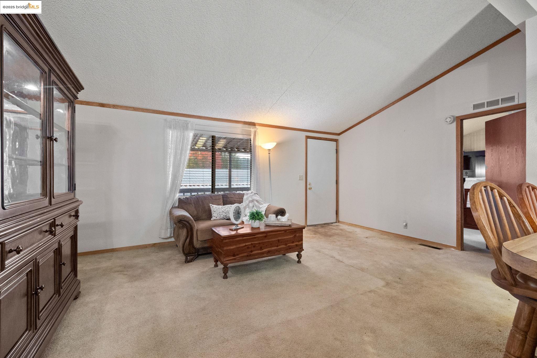 18717 Mill Villa Road, Unit 340 Jamestown, CA 95327 - Photo 4 of 21 a living room with furniture and a flat screen tv