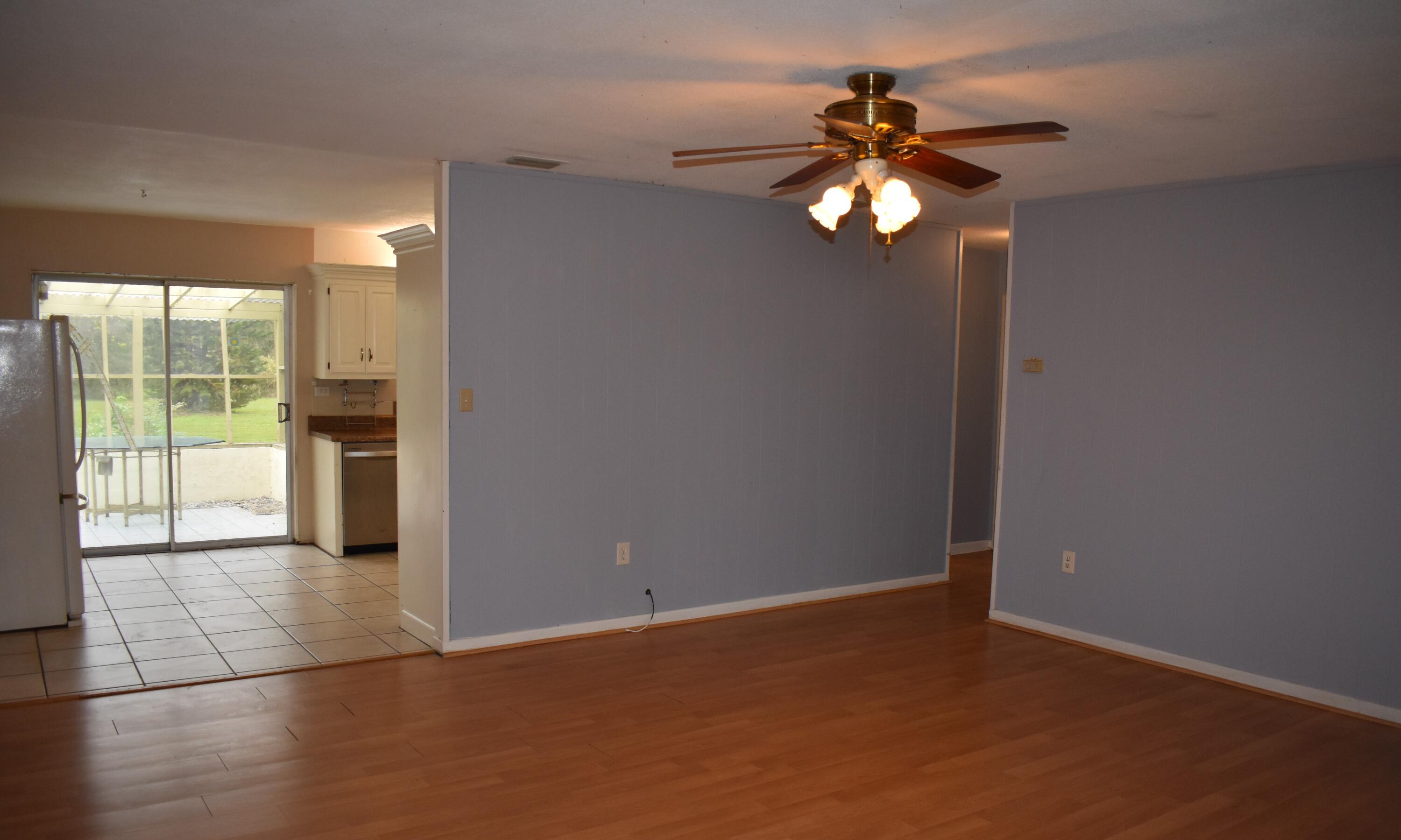 1812 Pinewood Road Melbourne, FL 32934 - Photo 5 of 31 a view of an empty room with window and wooden floor
