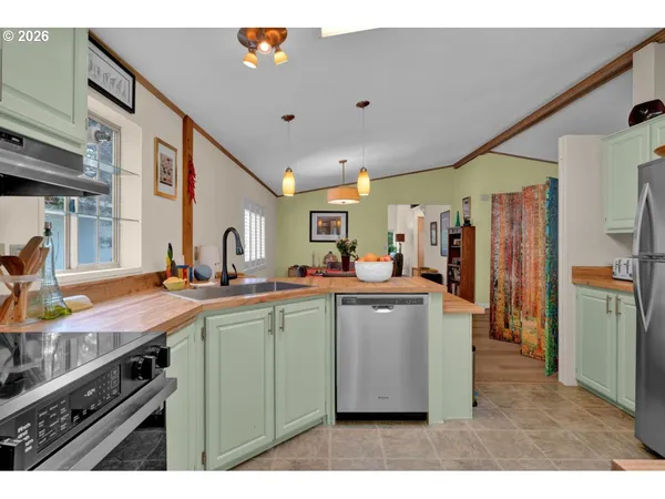 a kitchen with stainless steel appliances granite countertop a sink a stove and a microwave