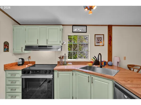 a kitchen view with stainless steel appliances granite countertop a refrigerator and a sink