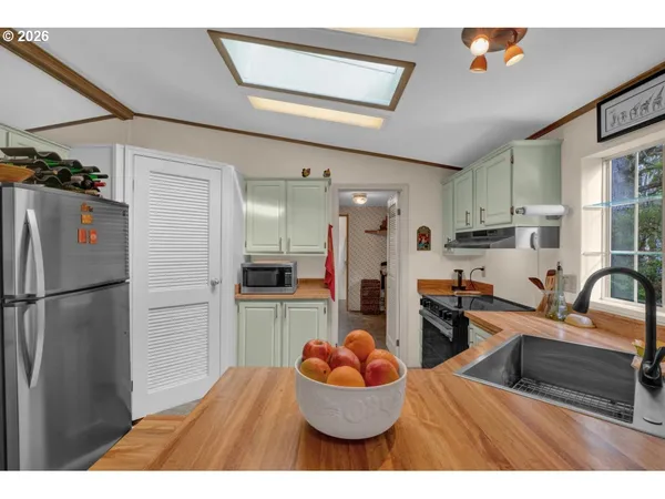 a kitchen with refrigerator and cabinets