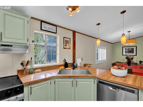 a kitchen with a dining table and chairs