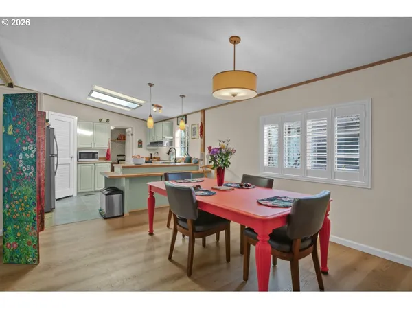 a dining room with furniture and wooden floor