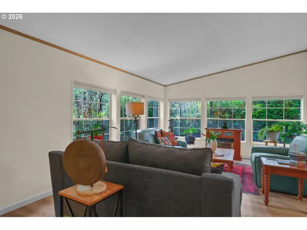 a living room with furniture a large window and a chandelier