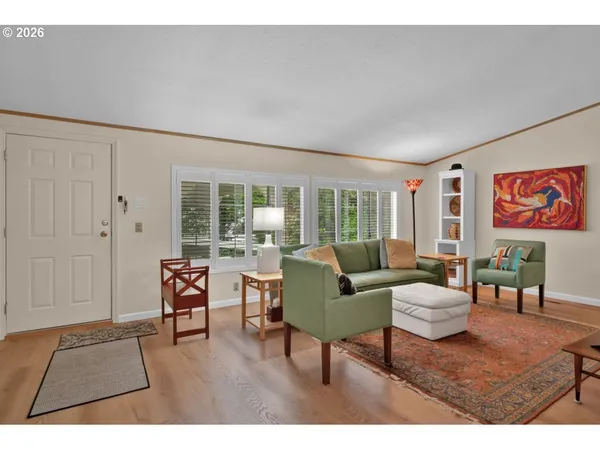 a living room with furniture and a floor to ceiling window