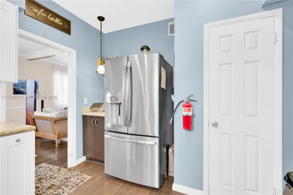 a white refrigerator freezer and a table in a kitchen