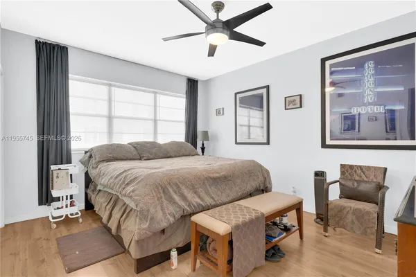 a spacious bedroom with a bed and window