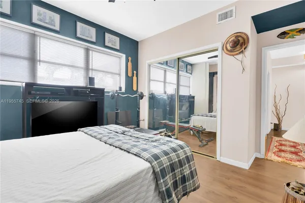 a bedroom with a bed and a large window with the outer view