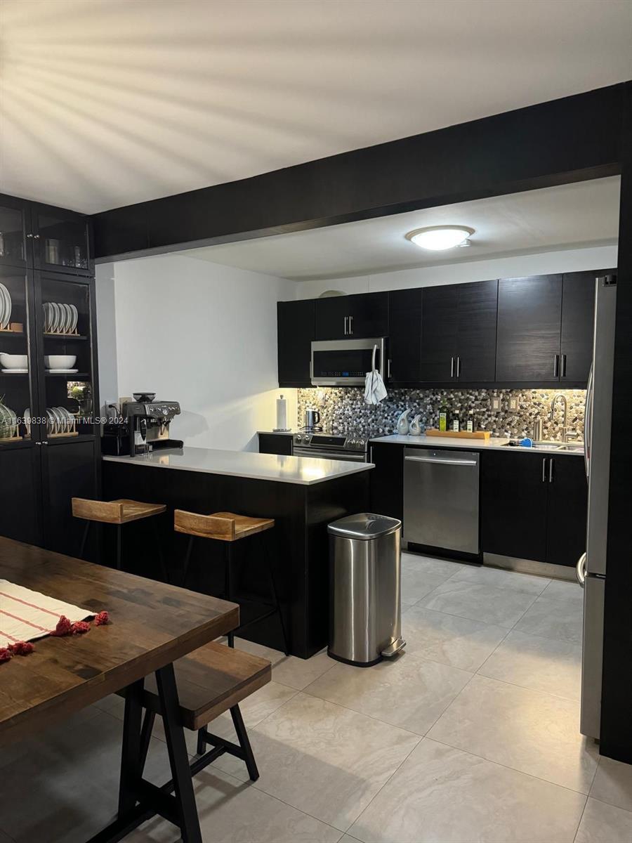 600 Northeast 36th Street, Unit 204 Miami, FL 33137 - Photo 13 of 31 a kitchen with a sink and cabinets