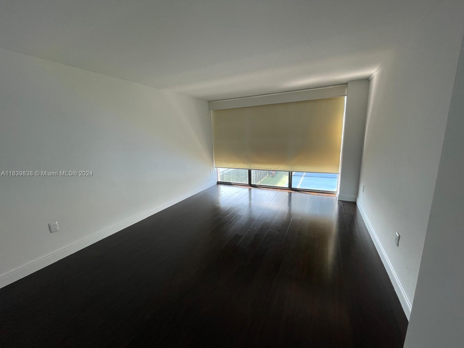 600 Northeast 36th Street, Unit 204 Miami, FL 33137 - Photo 23 of 31 a view of an empty room with wooden floor