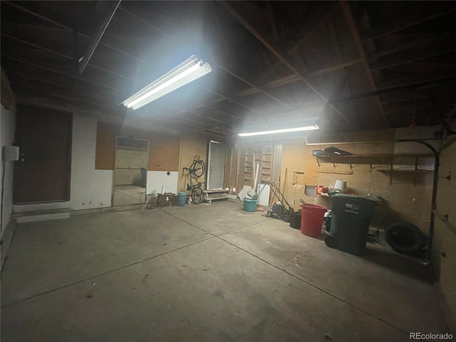 3817 South Ceylon Way Aurora, CO 80013 - Photo 15 of 18 a room with gym equipment and car parked