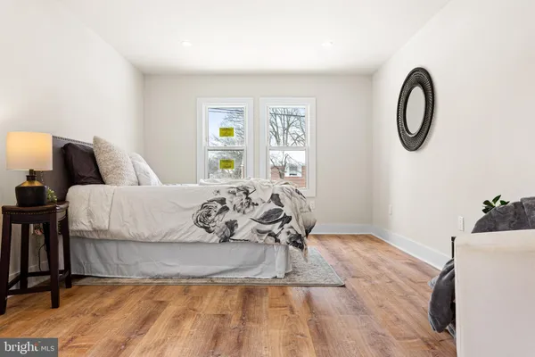 a bedroom with a bed and a dresser with mirror