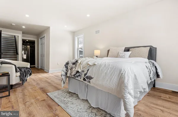 a bed room with a bed and a chair