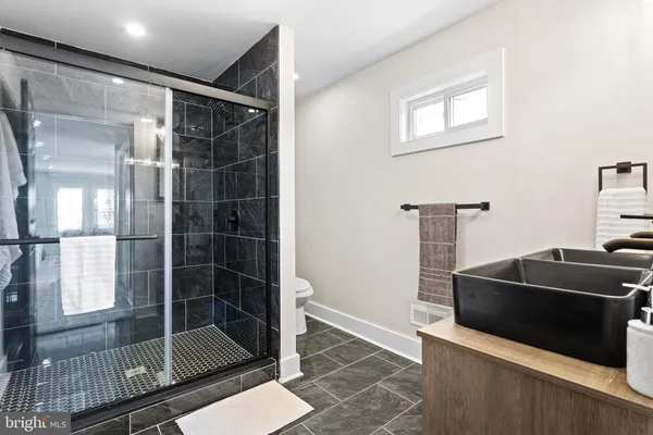 a bathroom with a shower and a sink